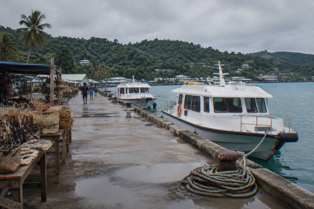 Cruise tender boats moored along the Port Vila seafront near the market stalls
