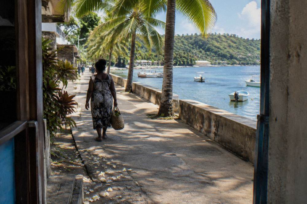 Palm-lined seafront promenade in central Port Vila on a clear afternoon