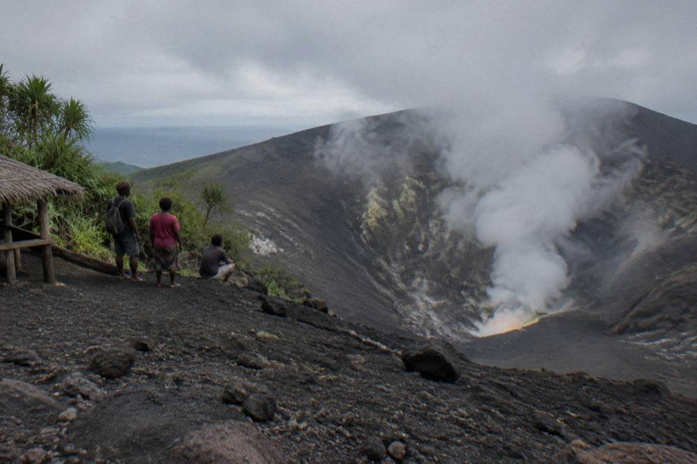 Steam and gas rising from the Mount Yasur crater under a grey sky