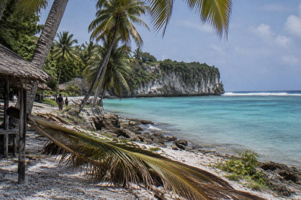 Turquoise lagoon water ringed by palm trees on Efate
