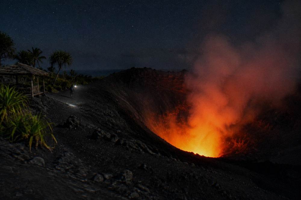 A volcanic crater rim under a wide sky on Tanna Island at dusk