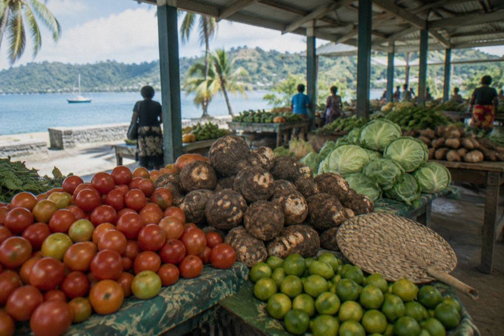 Colourful tropical produce stalls under a market roof in Port Vila
