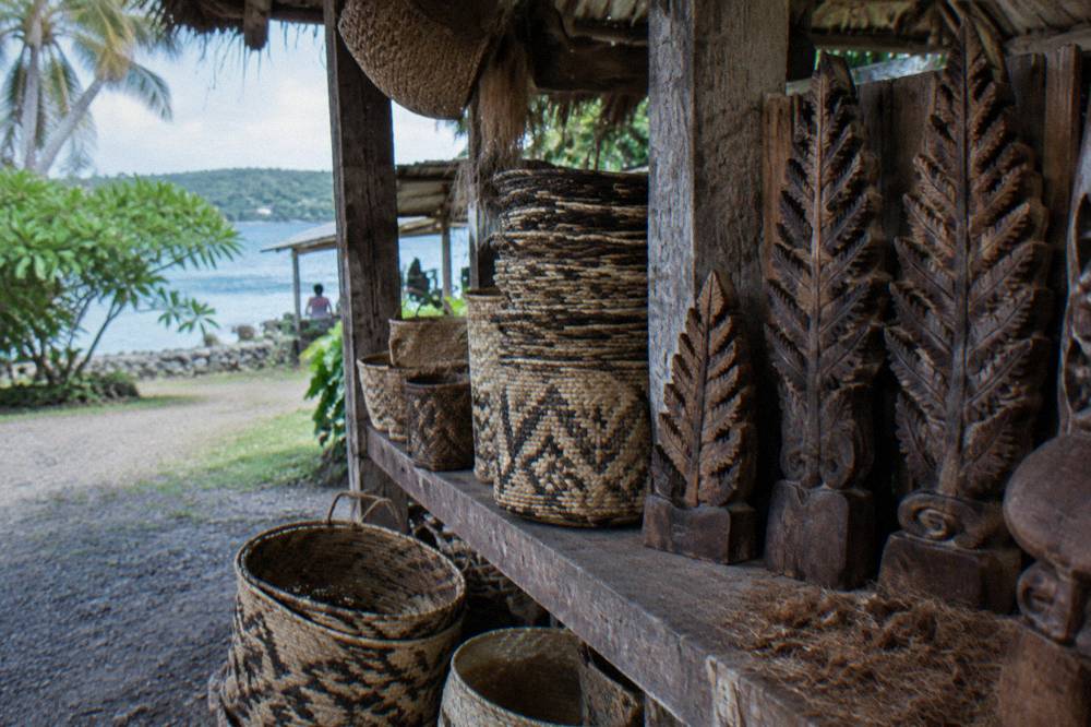 Handwoven baskets and wooden carvings displayed at a handicraft stall