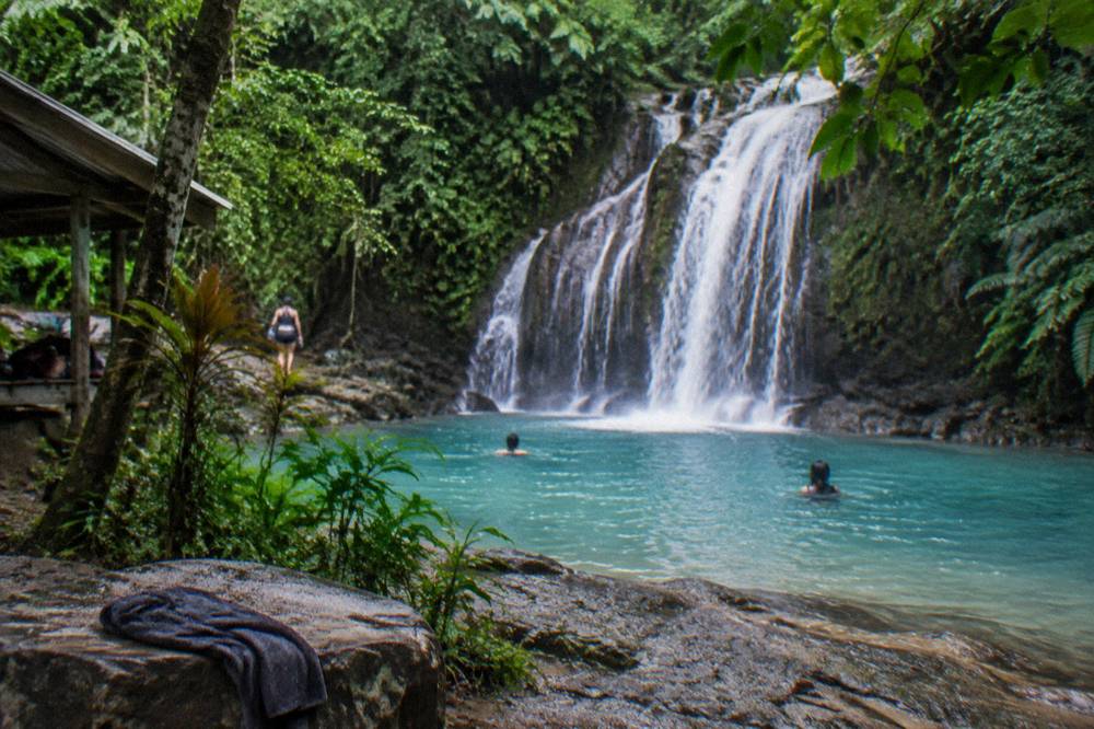 Turquoise lagoon water surrounded by dense green jungle