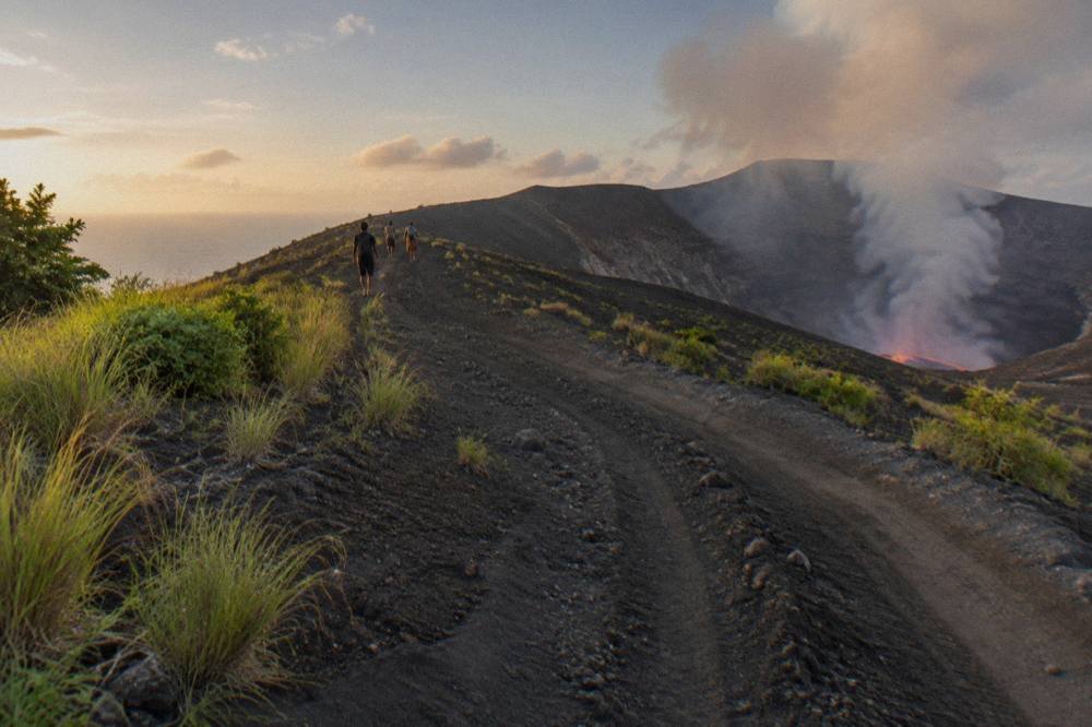 A four wheel drive track climbing the ash plain toward the crater rim of Mount Yasur